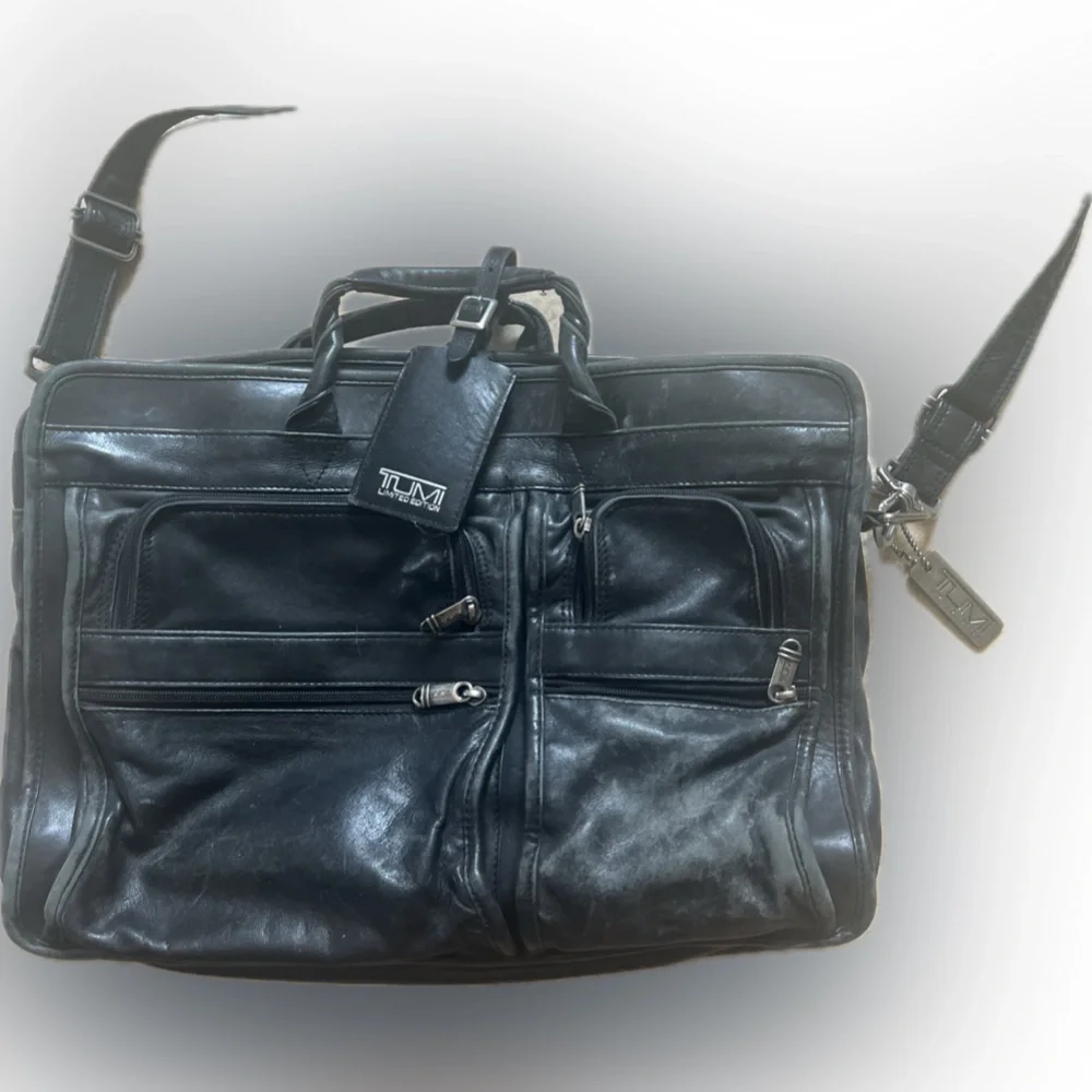 Tumi leather laptop briefcase. Chunky hardware, soft black quality leather.